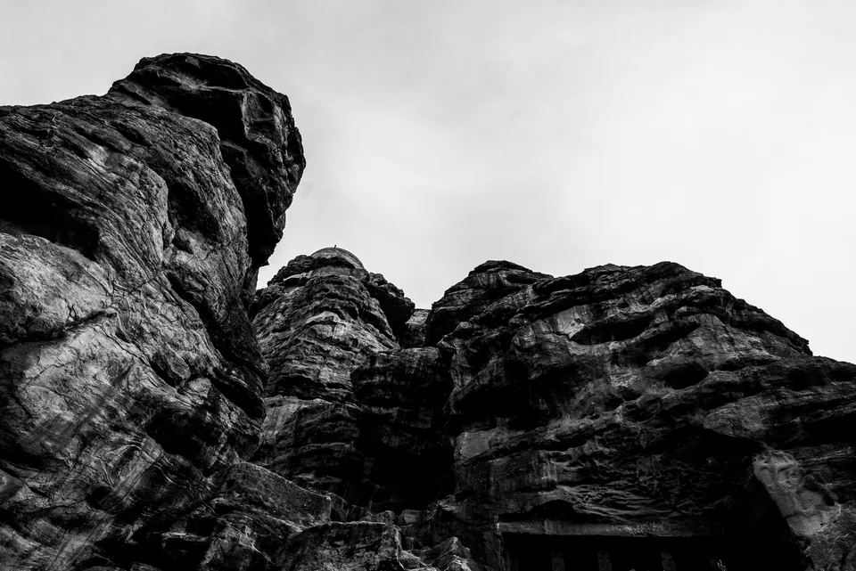 Wind-carved rock towers against a pale sky, every crease rendered in rich black and white.