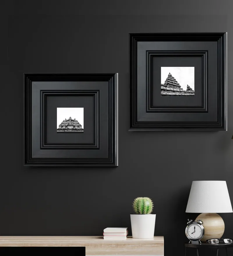 Classic stepped moulding: Deep, stepped black mouldings around small, square prints.